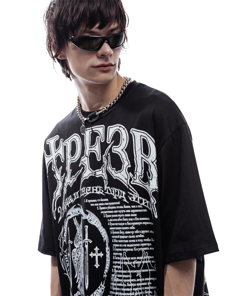 Person wearing a black t-shirt with white text and graphics on a white background